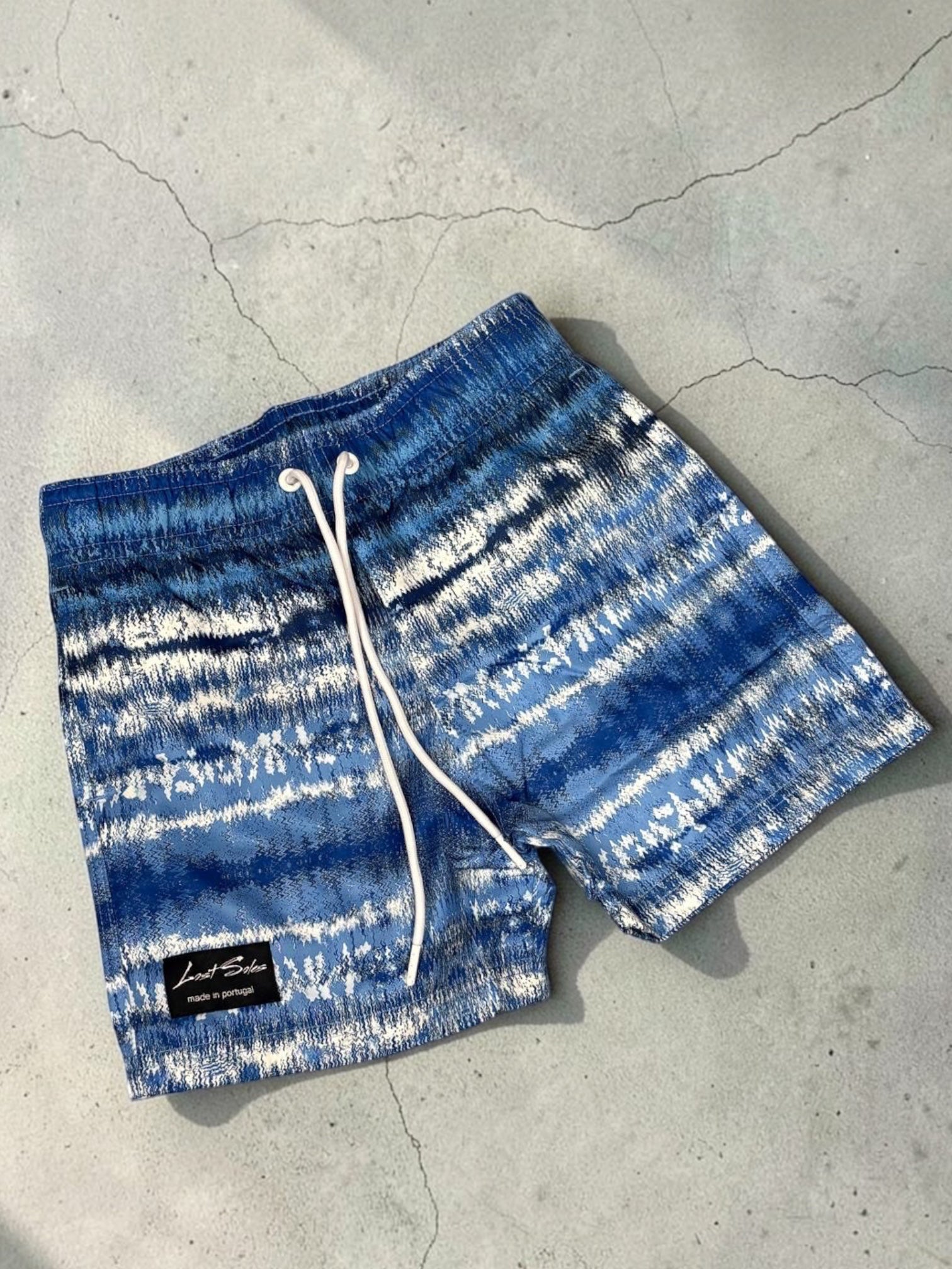 Kids swim shorts (blue, black badge)